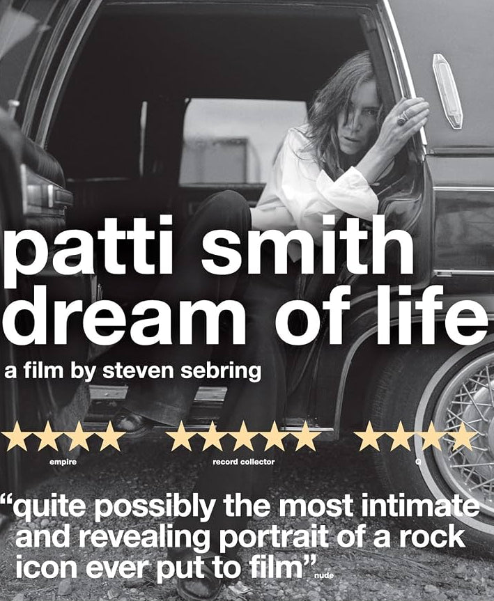Blu-ray cover for the film 'Patti Smith: Dream of Life' by Steven Seabring, featuring a black-and-white photo of Patti Smith sitting in a car door with the blue Blu-ray case border visible.